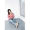 Depressed young black woman sitting against wall on floor