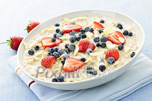 Bowl of hot oatmeal breakfast cereal with fresh berries