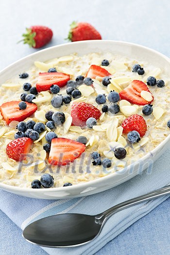 Bowl of hot oatmeal breakfast cereal with fresh berries Bowl of hot oatmeal breakfast cereal with fresh berries