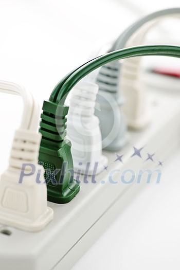 Many plugs plugged into electric power bar Many plugs plugged into electric power bar