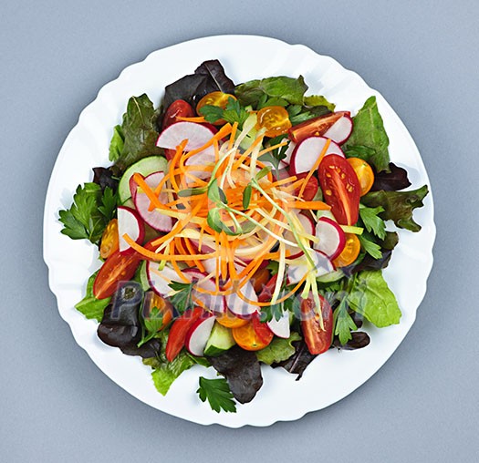 Plate of healthy green garden salad with fresh vegetables from above Plate of healthy green garden salad with fresh vegetables from above