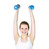 Happy healthy fit young woman lifting weights for fitness exercise