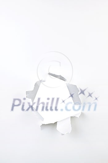 Paper with ripped hole and torn edges over white Paper with ripped hole and torn edges over white