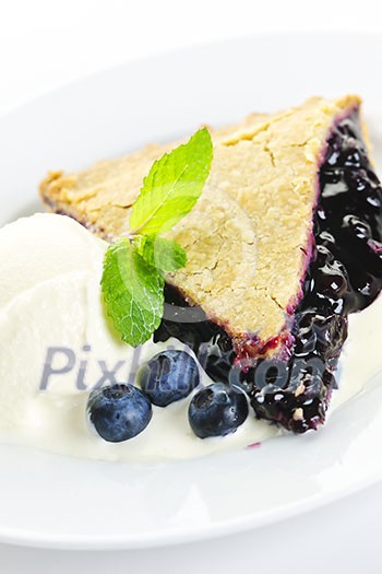 Slice of blueberry pie with vanilla ice cream and berries Slice of blueberry pie with vanilla ice cream and berries