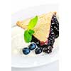 Slice of blueberry pie with vanilla ice cream and berries