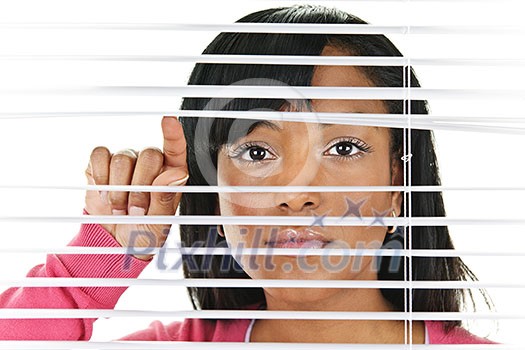 Young black woman looking through horizontal venetian blinds Young black woman looking through horizontal venetian blinds