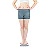 Healthy young woman standing on bathroom scale isolated on white