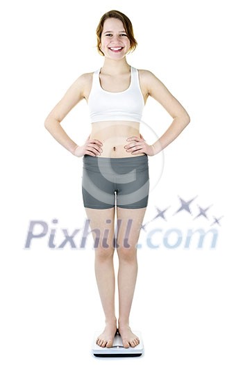 Happy young woman standing on bathroom scale isolated on white Happy young woman standing on bathroom scale isolated on white