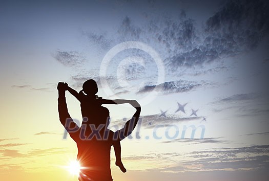 Father and little daughter silhouettes on sunset background Father and little daughter silhouettes on sunset background