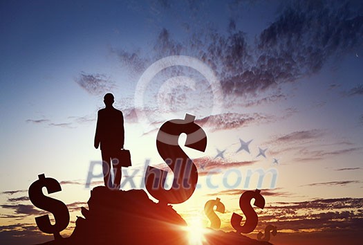 Silhouette of businessman standing with back on hill top Silhouette of businessman standing with back on hill top