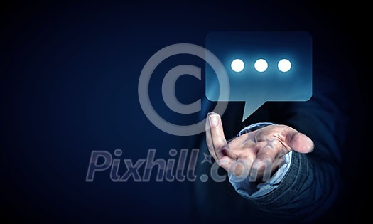 Close up of businessman hand holding chat icon Close up of businessman hand holding chat icon