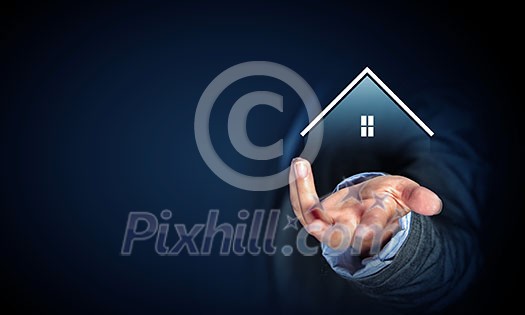 Close up of businessman holding real estate icon in palm on dark background Close up of businessman holding real estate icon in palm on dark background