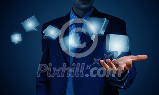 Close up of businessman hand holding chat icon Close up of businessman hand holding chat icon