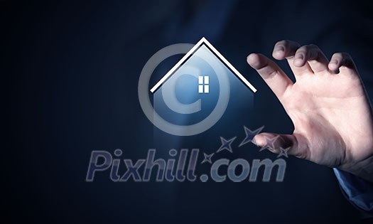 Close up of businesswoman holding real estate icon in palm on dark background Close up of businesswoman holding real estate icon in palm on dark background