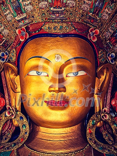 Vintage retro effect filtered hipster style image of Maitreya Buddha statue face close up in Thiksey Gompa. Ladakh, India Vintage retro effect filtered hipster style image of Maitreya Buddha statue face close up in Thiksey Gompa. Ladakh, India