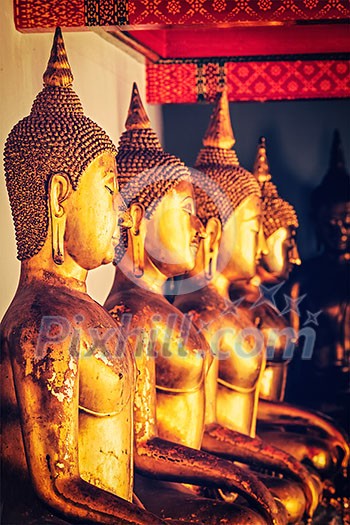Vintage retro effect filtered hipster style image of sitting Buddha statues in Buddhist temple Wat Pho, Bangkok, Thailand Vintage retro effect filtered hipster style image of sitting Buddha statues in Buddhist temple Wat Pho, Bangkok, Thailand