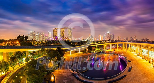 Singapore travel tourism concept - panorama of Singapore skyline illumintaed in the evening twilight Singapore travel tourism concept - panorama of Singapore skyline illumintaed in the evening twilight