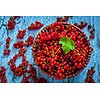 Redcurrant red currant berries in wicker bowl on kitchen table