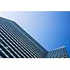 Exterior of building - abstract concept; skyscraper from down below against blue sky