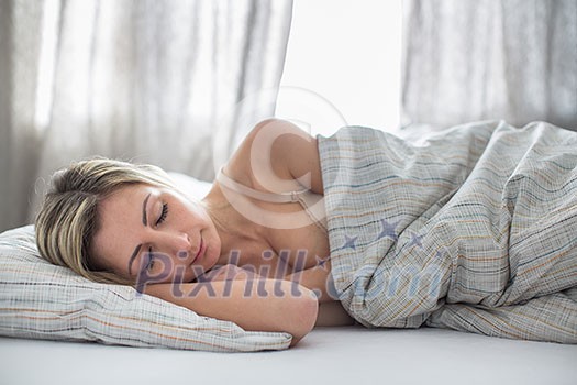 Beautiful young woman sleeping in bed (shallow DOF; color toned image) Beautiful young woman sleeping in bed (shallow DOF; color toned image)