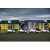 Concrete production plant/factory with  Concrete mixing transport trucks in front of it