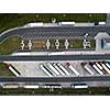 Aerial view of a highway amid fields with cars on it