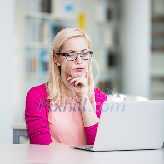 Pretty young college student in a library (shallow DOF; color toned image) Pretty young college student in a library (shallow DOF; color toned image)
