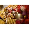 Man playing on a tibetian singing bowl (shallow DOF; color toned image)
