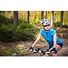 Pretty, young female biker outdoors on her mountain bike (shallow DOF; selective focus)