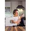 Beautiful young woman sewing clothes with sewing machine (color toned image; shallow DOF)
