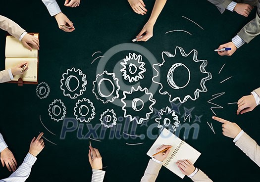 Top view of people hands drawing teamwork strategy Top view of people hands drawing teamwork strategy