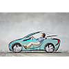 Young humorous woman driving drawn funny car