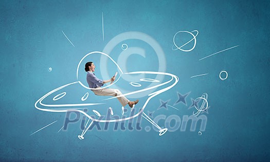 Young funny woman riding in drawn ufo ship Young funny woman riding in drawn ufo ship