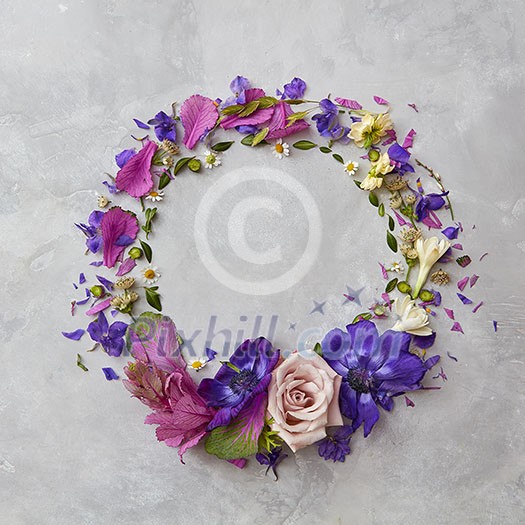 round frame of spring colored flowers on a gray background round frame of spring colored flowers on a gray background