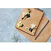 Top view of craft notebook with flower decoration with pencil on concrete background, overhead view