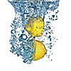 Fresh lemon dropped into water with bubbles isolated on white