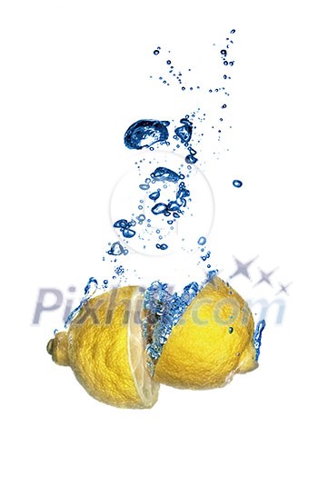 Fresh lemon dropped into water with bubbles isolated on white