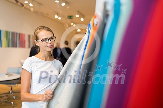 Pretty young woman choosing the right material/color for her modern house/appartement interior (shallow DOF; color toned image) Pretty young woman choosing the right material/color for her modern house/appartement interior (shallow DOF; color toned image)