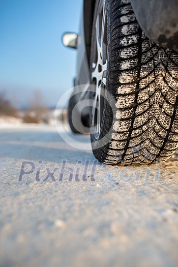 Car with winter tires on a slippery, snowy road