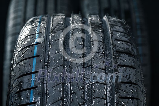 Stack of brand new high performance car tires on clean high-key white studio background Stack of brand new high performance car tires on clean high-key white studio background