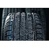 Stack of brand new high performance car tires on clean high-key white studio background