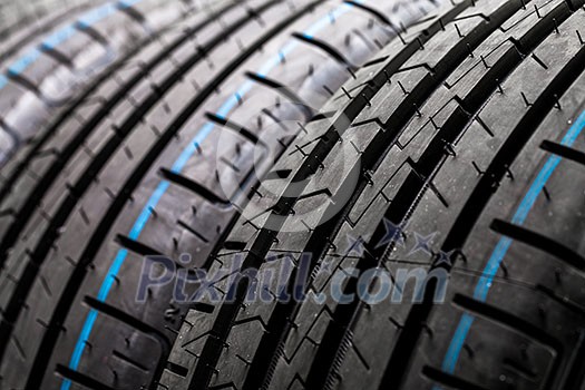 Stack of brand new high performance car tires on clean high-key white studio background Stack of brand new high performance car tires on clean high-key white studio background