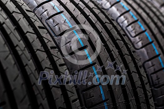 Stack of brand new high performance car tires on clean high-key white studio background Stack of brand new high performance car tires on clean high-key white studio background