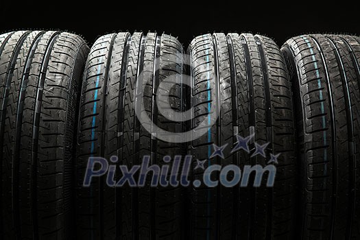 Stack of brand new high performance car tires on clean high-key white studio background Stack of brand new high performance car tires on clean high-key white studio background