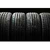 Stack of brand new high performance car tires on clean high-key white studio background