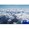 airplane's wing over a blue and cloudy sky