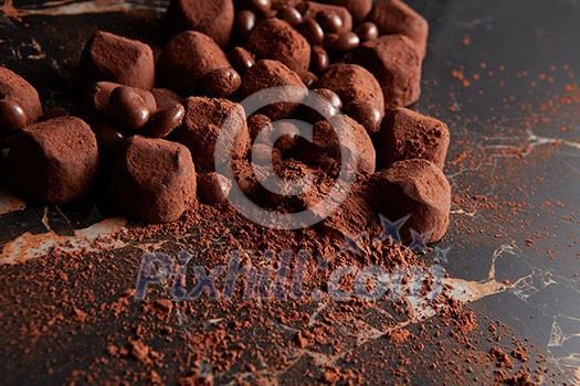 Luxury chocolate truffles on a black marble background. Luxury chocolate truffles on a black marble background.