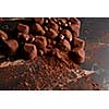 Luxury chocolate truffles on a black marble background.