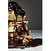 melted chocolate is poured on a stack of slices of white chocolate