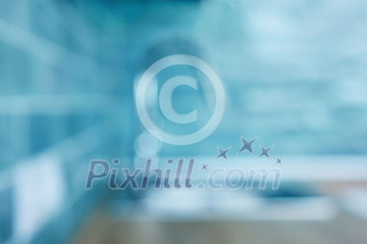 Modern kitchen mixer made of stainless steel on a background of ceramic blue tiles,natural lens bokeh. blurred background Modern kitchen mixer made of stainless steel on a background of ceramic blue tiles,natural lens bokeh. blurred background